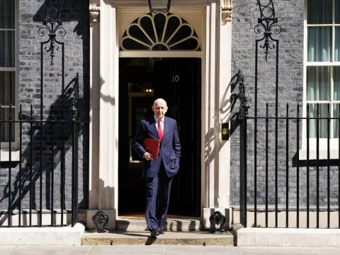 Image of the chancellor John Healy in front of Downing Street.