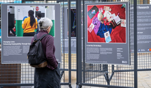 A community member stopping to look at an images of research poster