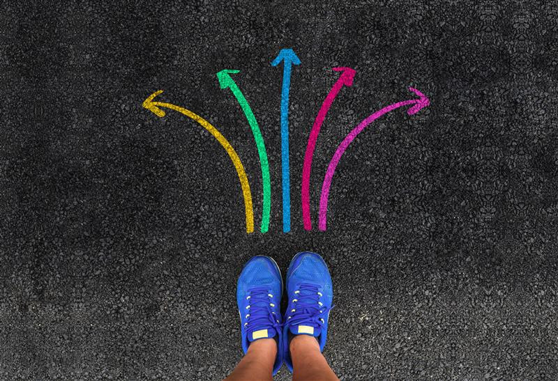 Image of a pair of shoes with colourful arrows around it