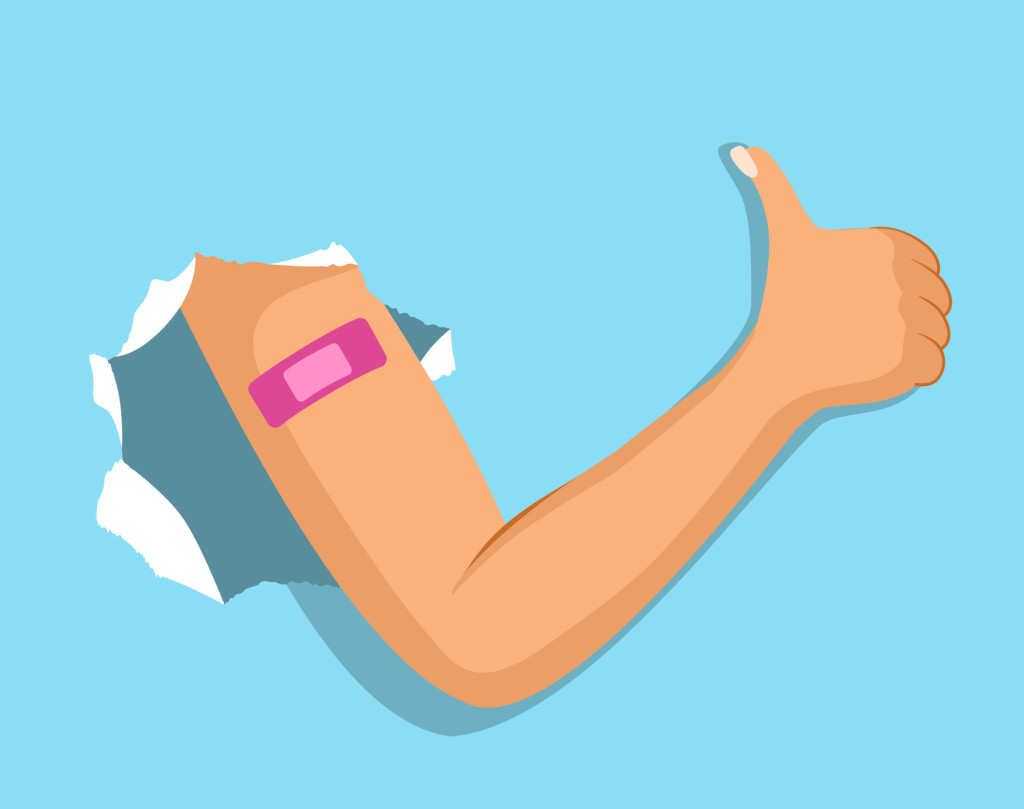 Arm breaks through paper blue background shows pink adhesive band making thumb up gesture.