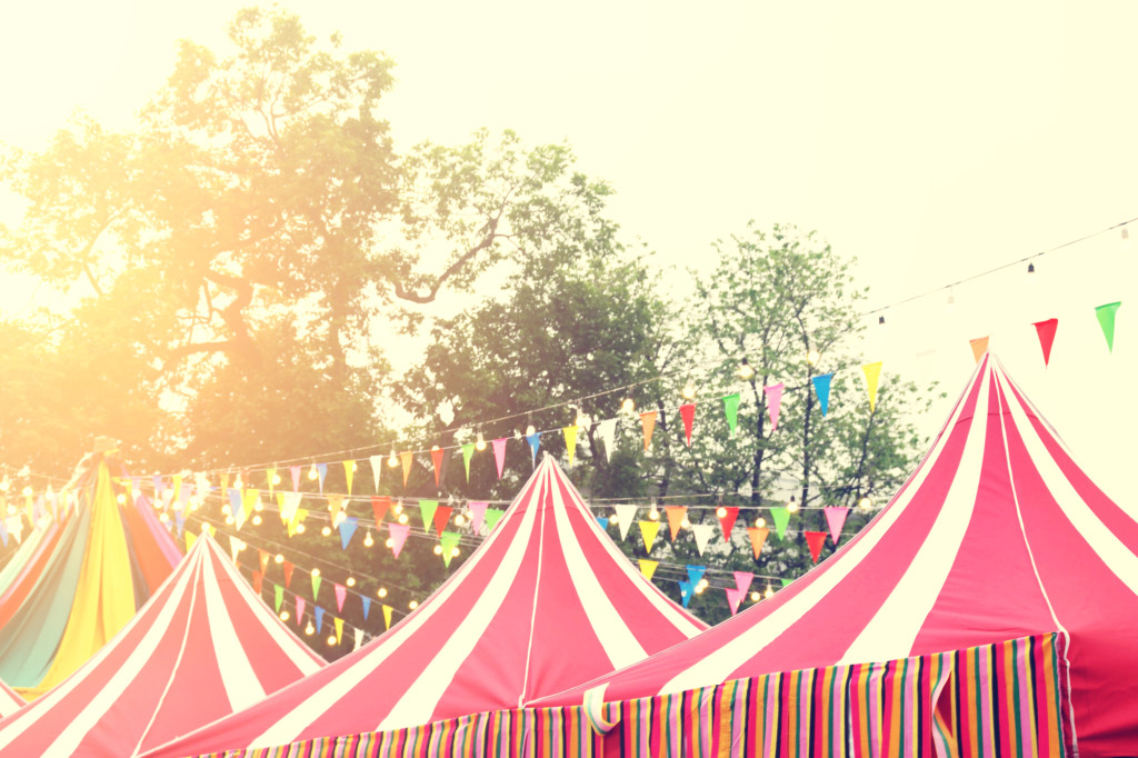 An image of red circus tents on a sunny day