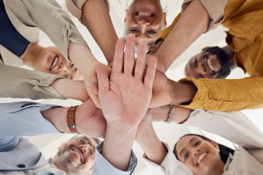 Image of a group of people putting their hand together