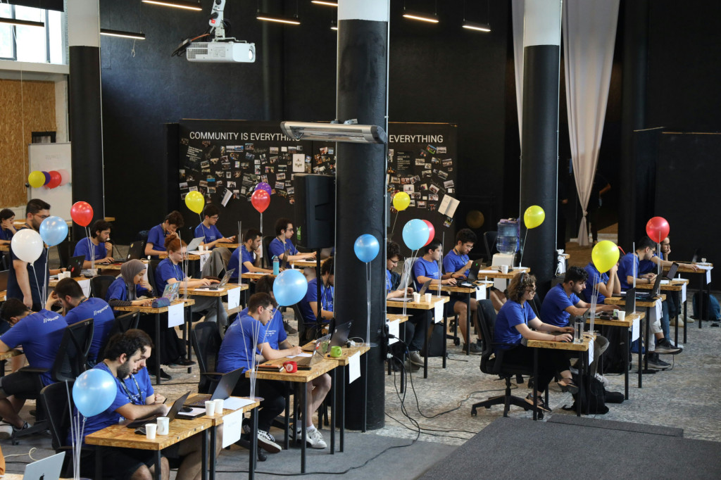 People sitting at tables with balloons.