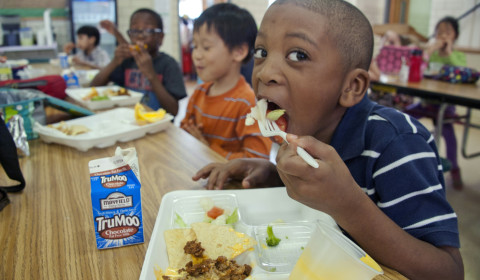 An image of school children eating lunch