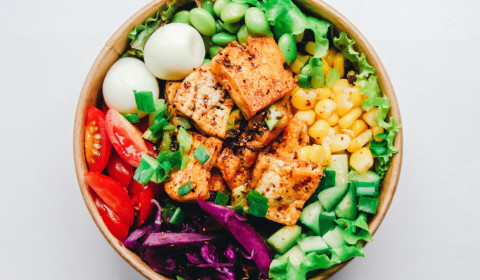 Bowl of healthy food - eggs, protein, tomatoes, greens. Photo by Anh Nguyen on Unsplash.