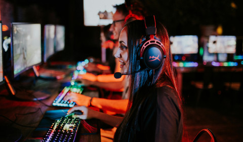 Photograph of people playing videogames on PCs