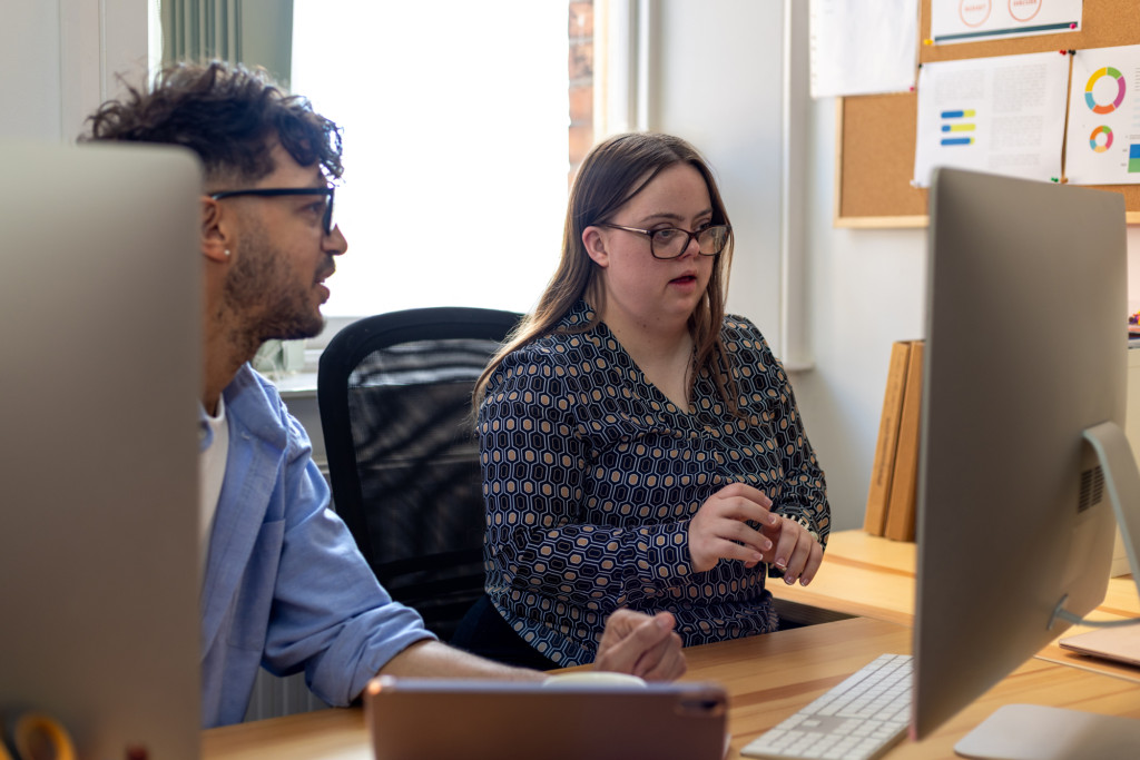 Two people looking at a computer screen.