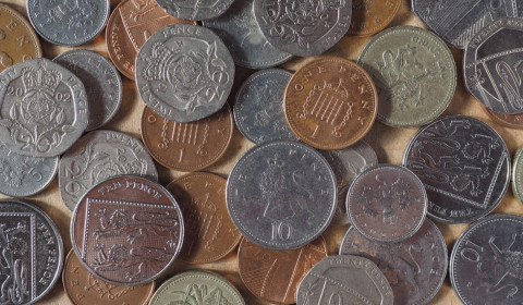 Photograph of 10p, 20p, 1p, 2p and 5p coins scattered on a table