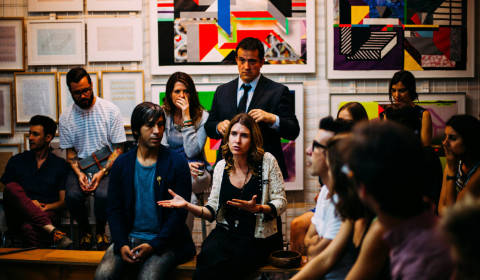 A group of people gather in debate and conversation.