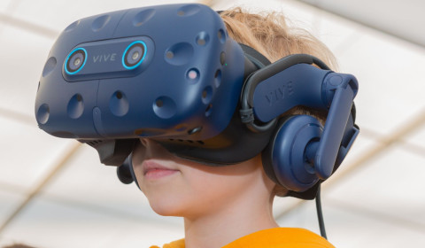 Image of a young boy wearing a virtual reality headset