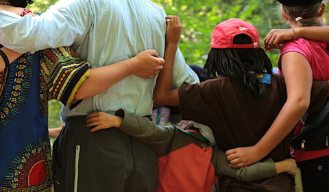 A picture of a handful of people embracing one another.
