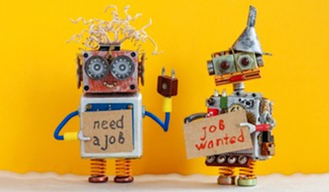 Two robots standing together with need a job and job wanted signs.