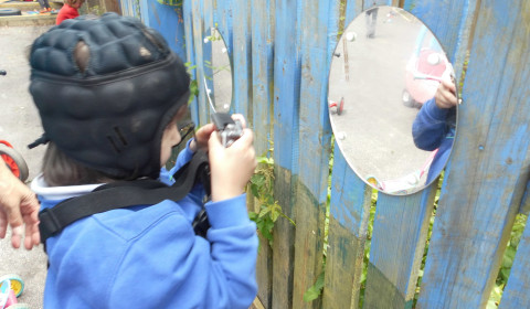 Child engaging with a reflective play space that supports movement and participation