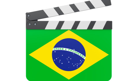 The image is a stylised film clapperboard (director’s slate) featuring the Brazilian flag.