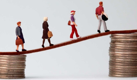 Small figures on a bridge made of piles of coins