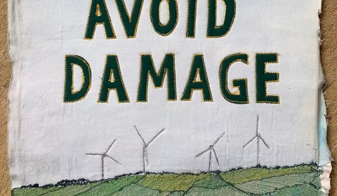 Wind turbines with a slogan - Please Avoid Damage