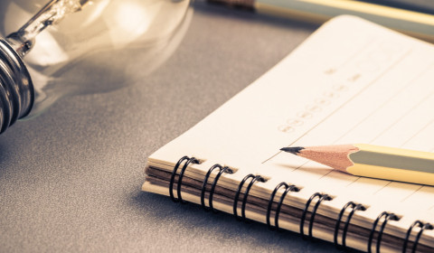 Photograph of a notebook and pencil on a desk