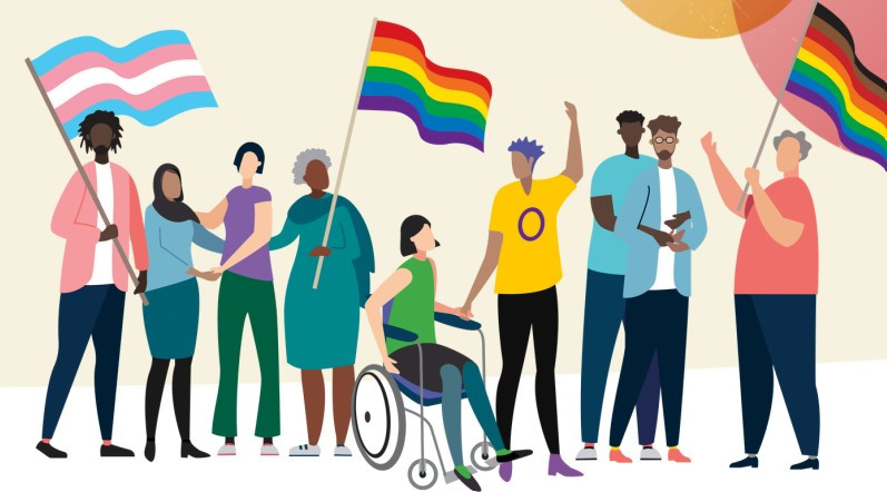 Image shows a group of people waving LGBT+ flags
