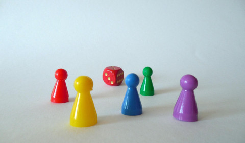 Image of a dice and characters from a table top game