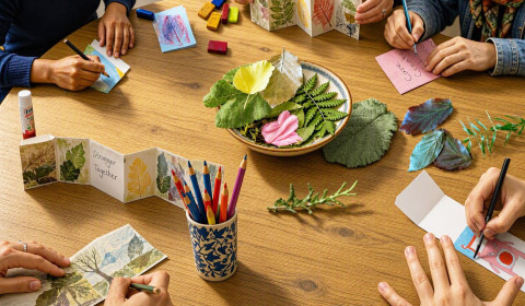 image showing hands of a group of people doing an arts-based activity together