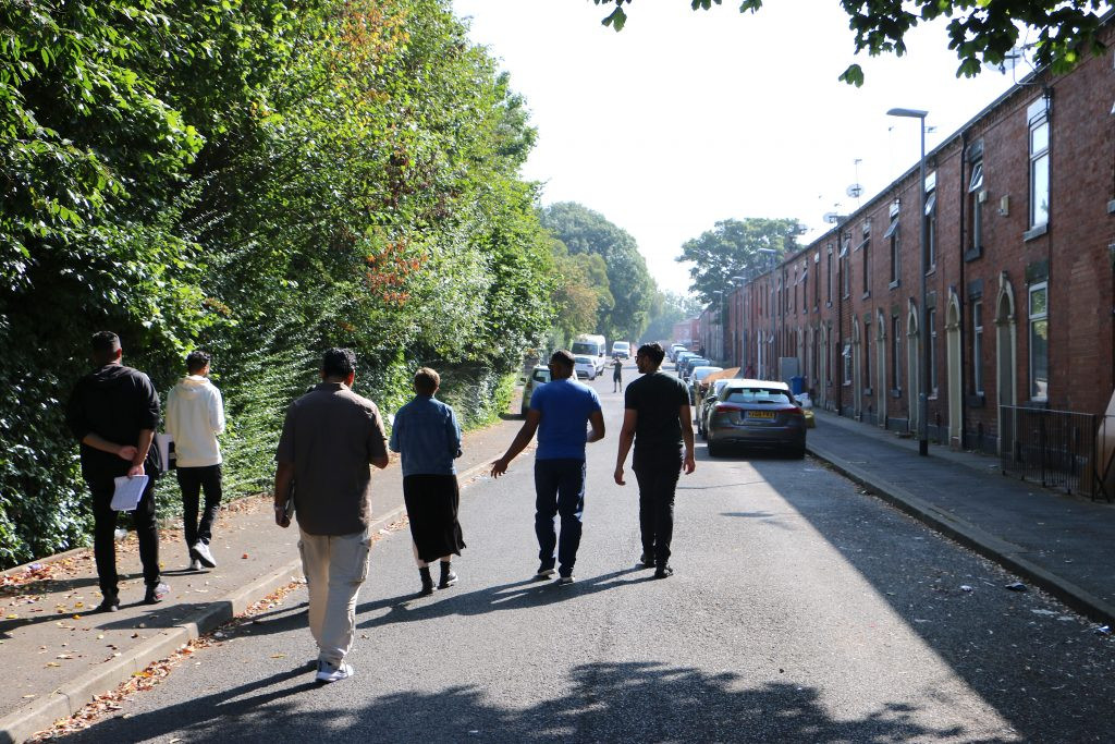 Photograph of people walking down a street