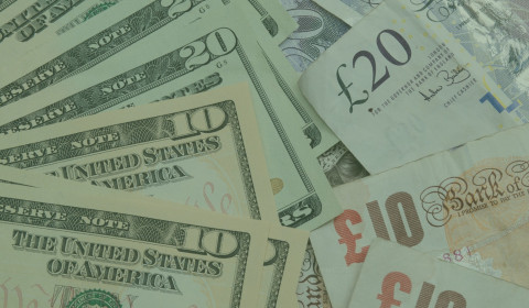 Image of US bank notes alongside Bank of England bank notes