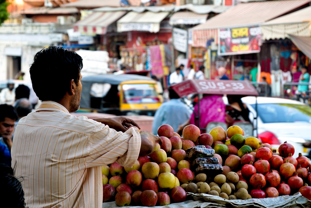 Image of a man waiting to sell produce from his fruit market