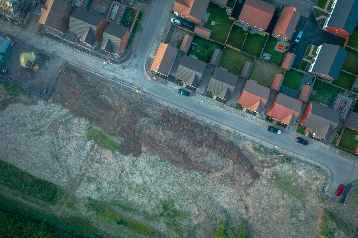 Aerial image of houses next to a development site