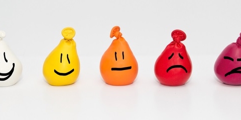Different coloured balloons with different facial expressions