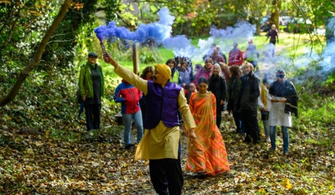 Man leading a group with blue smoke
