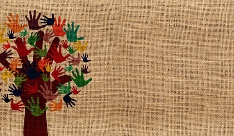 Printed image of a tree on hessian fabric. The tree is comprised of various different colour hand prints.