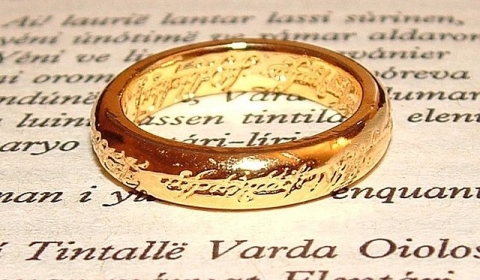 A page of text with a gold ring on top
