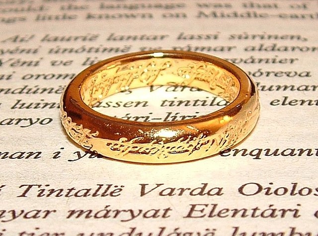A page of text with a gold ring on top